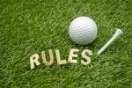 al golf ball in the grass with the word rules