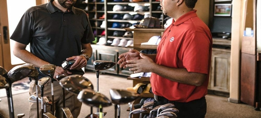 two men in a golf pro shop
