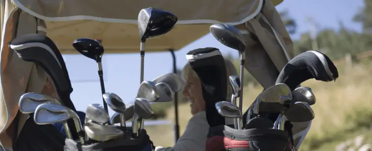 multiple golf clubs in a cart