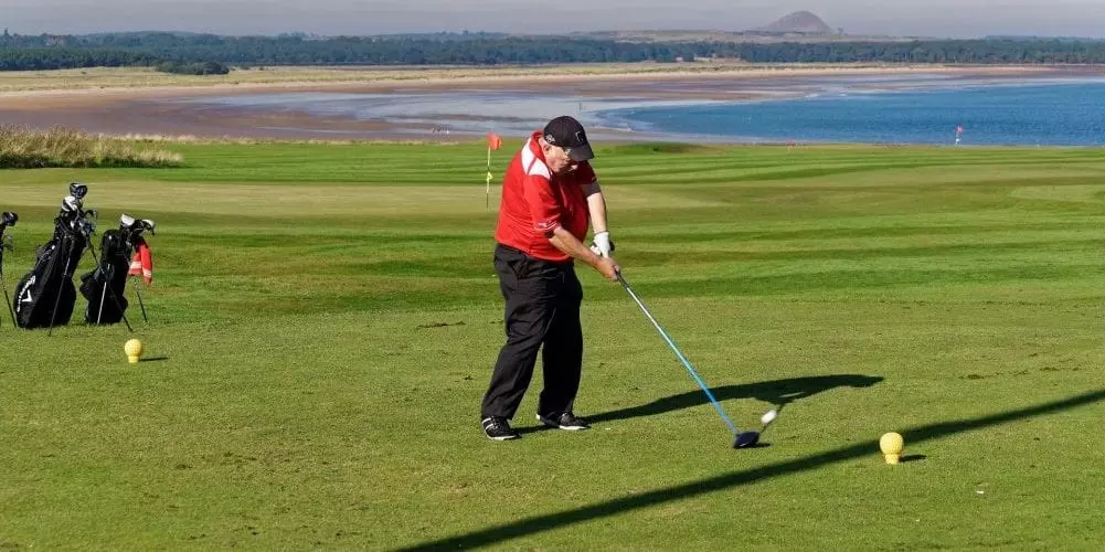 a man doing a golf swing