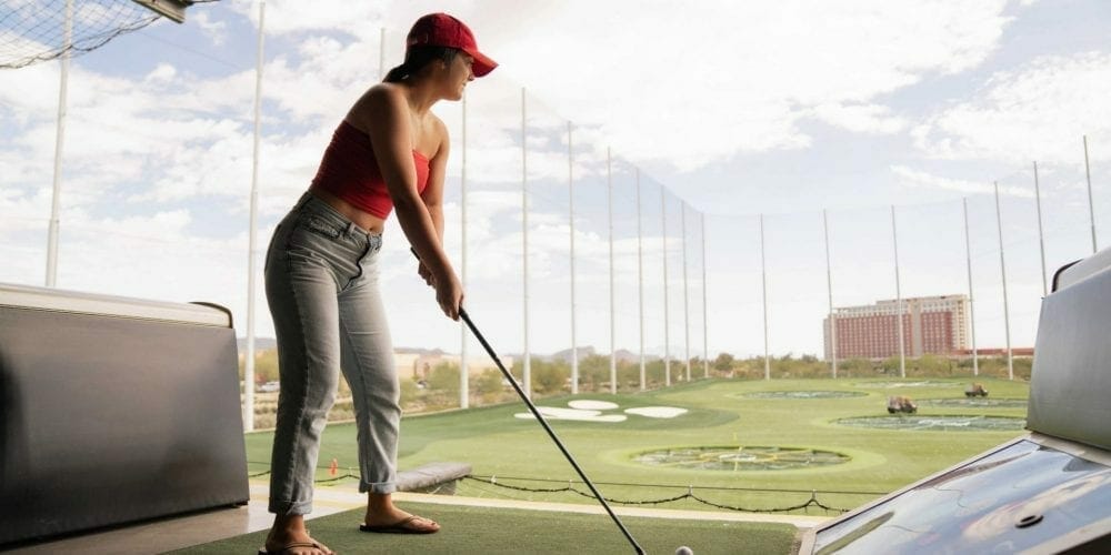 a woman in the driving range