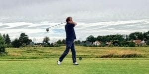 a man driving the golf ball