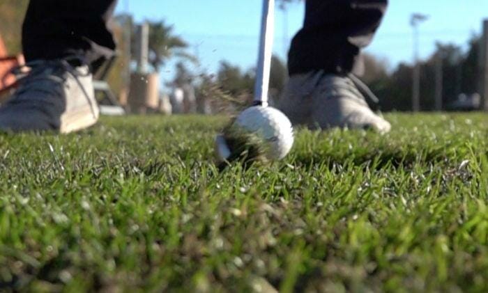 golfer hitting the golf ball