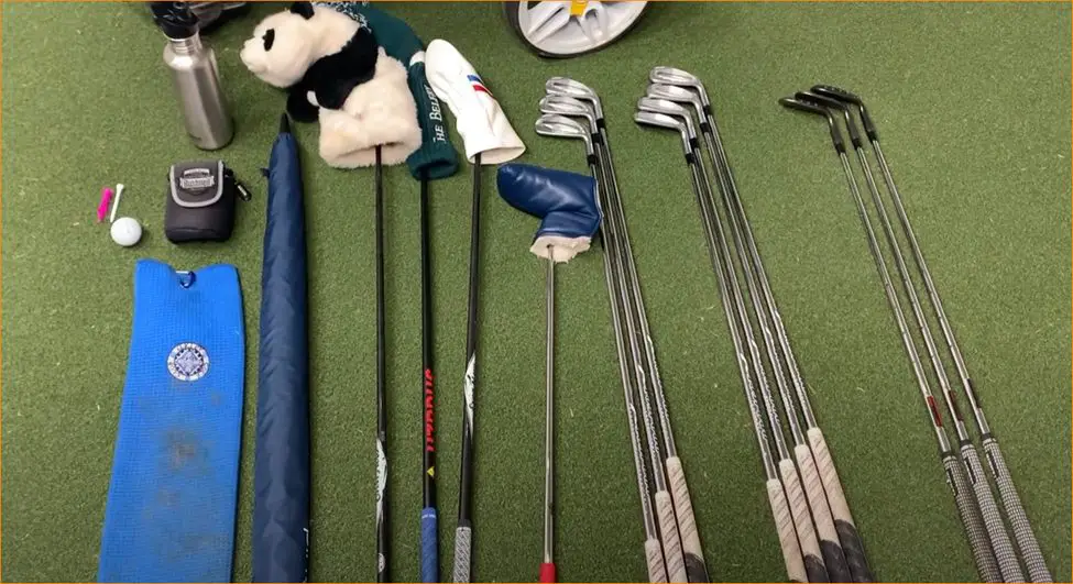 golf accessories laid on the golf grass