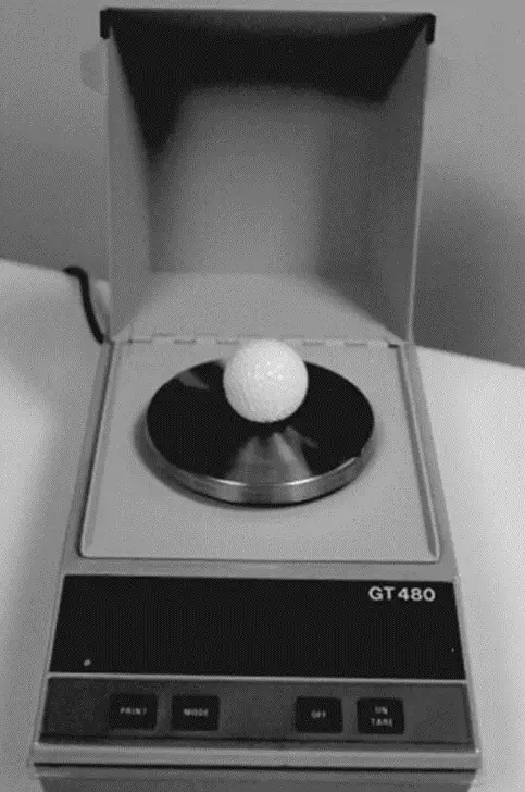golf ball being weigh