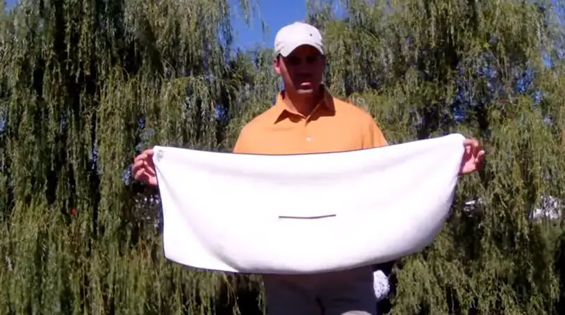 man holding golf towel