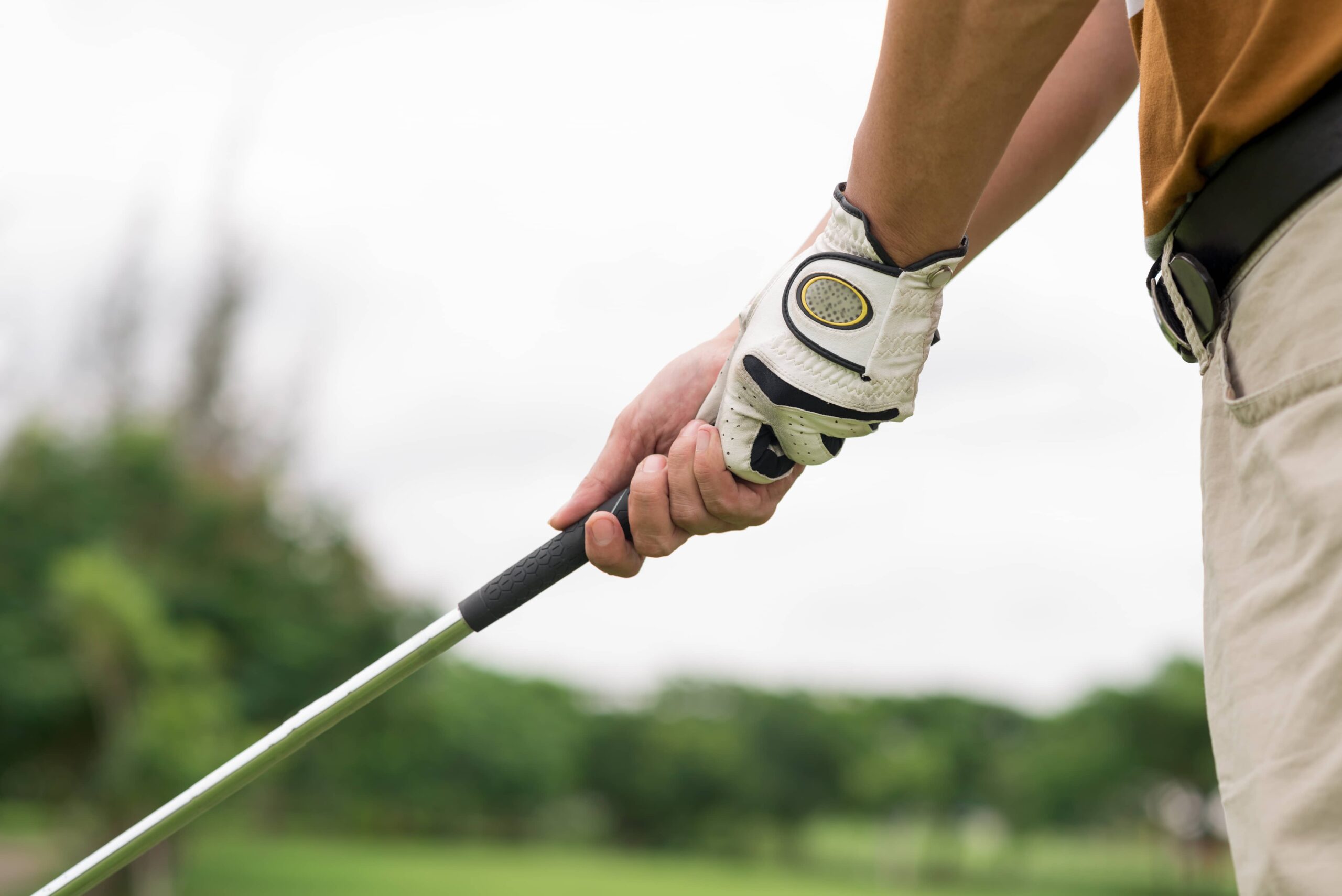 Gripping the golf club to avoid a slice