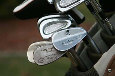 A collection of wedge golf clubs